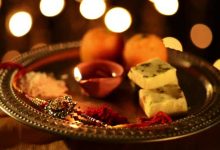 Spinning Puja Thali With Rakhi, Sweets And Oil Lamp
